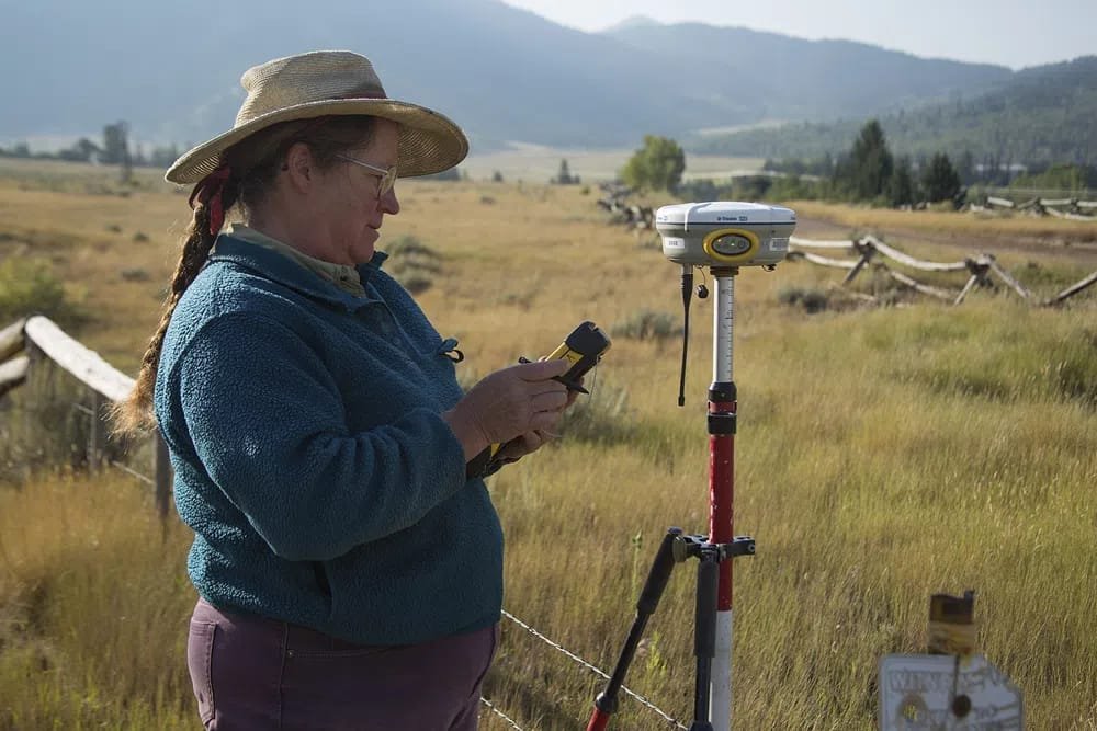 Professional land surveyor measuring property boundaries